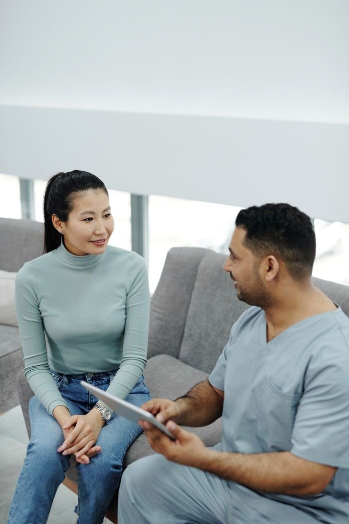 A doctor and patient engaging in a consultation indoors, focusing on health and communication.